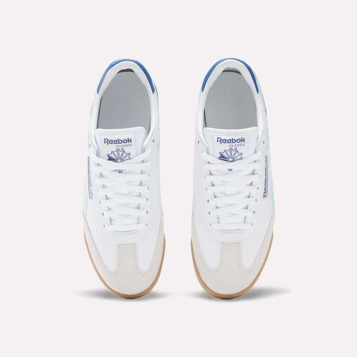 A pair of white Reebok Campio XT Shoes for Big Kids with blue accents, seen from above. These leather sneakers feature white laces, gum soles, and the blue Reebok logo on the tongue and side.