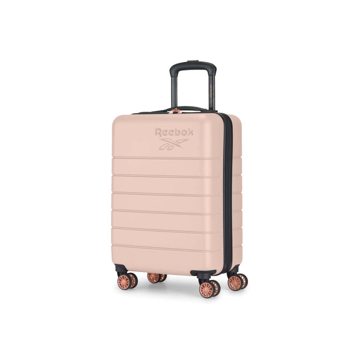 A light pink hard-shell Reebok suitcase with four double wheels and a black telescopic handle, shown standing upright on a white background.