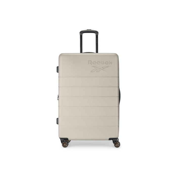 A beige Reebok Captain 2 Piece Luggage Set hard-shell suitcase, featuring four spinner wheels, a black telescopic handle, and an embossed logo on the front, stands upright against a white background.