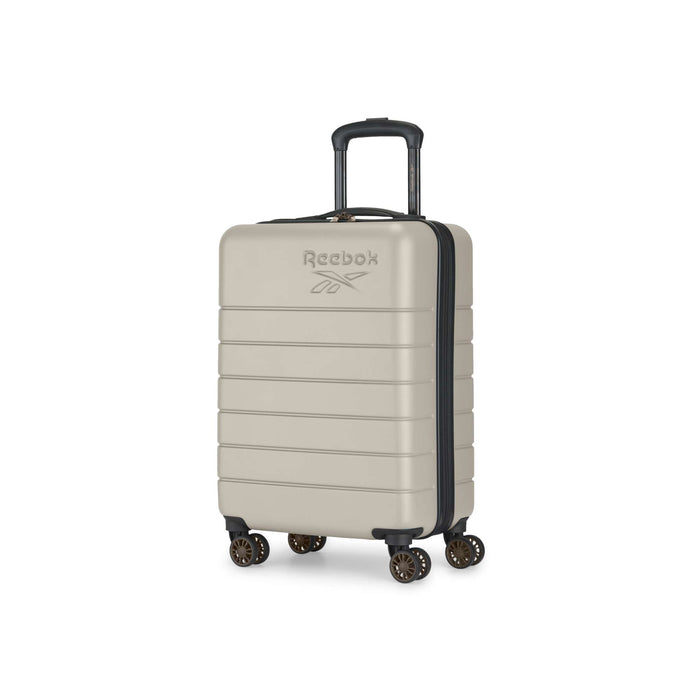 This beige Reebok Captain 2 Piece Luggage Set features a hard shell with horizontal ridges, four spinner wheels, a telescopic handle, and the Reebok logo on the front, shown against a white background.