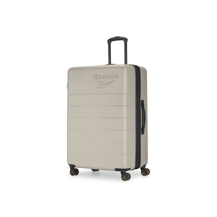 The Reebok Captain 2 Piece Luggage Set features a beige hard-shell case with four spinner wheels, retractable and side handles, and an embossed Reebok logo. This durable luggage stands upright against a white background.