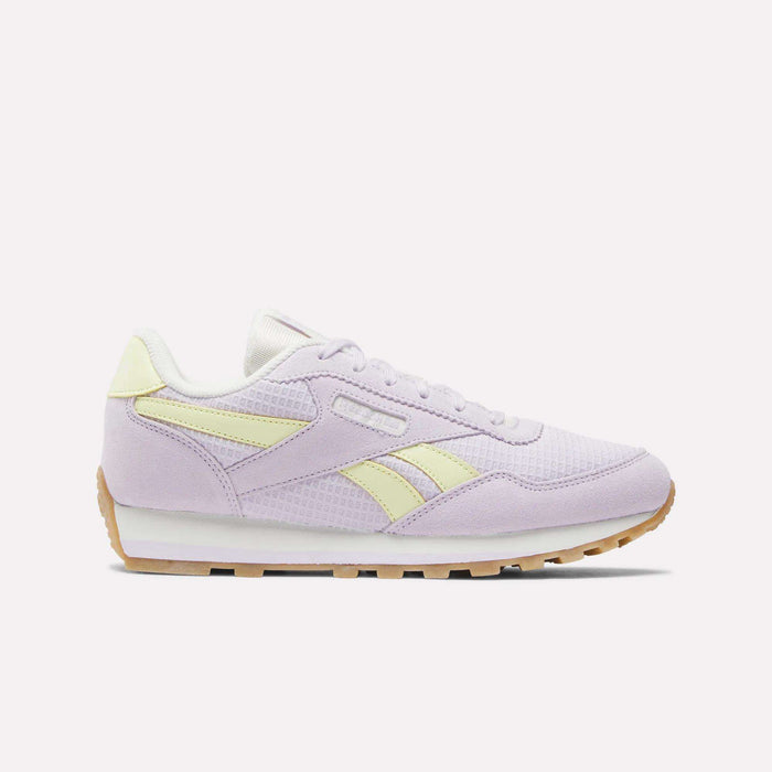 A single Reebok Classic AZ Shoe for big kids in pastel purple with light yellow accents, white laces, foam cushioning, a white midsole, and a tan rubber outsole—displayed on a plain white background.