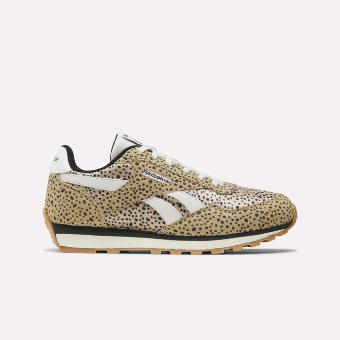 The Reebok Classic AZ Shoes for big kids feature a tan upper with black spots, white laces, and white Reebok logos. These low-top sneakers have a black and gum sole for a retro look—perfect for junior girls seeking style.