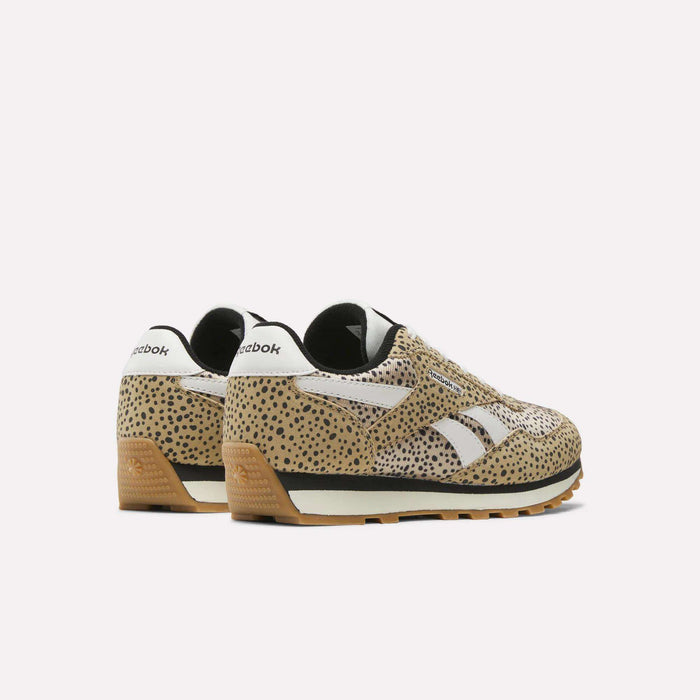 The Reebok Classic AZ Shoes for big kids feature a tan and black spotted animal print, white side stripes, black accents, white heel detailing, and brown rubber soles, shown on a white background.