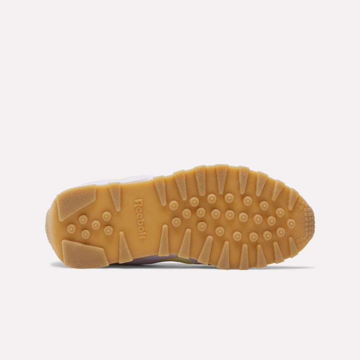 A close-up of the Reebok Classic AZ Shoes - Big Kids highlights the textured gum outsole with circular and rectangular tread patterns, showcasing heritage-inspired design features against a plain white background.