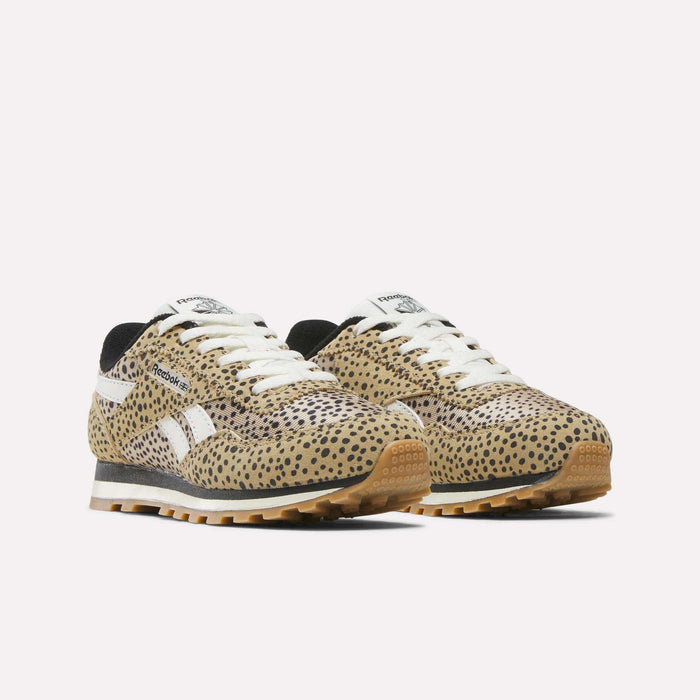 A pair of Reebok Classic AZ Shoes - Little Kids are shown with a tan, black, and brown cheetah print, white laces and logos, black lining, and a light brown rubber sole against a plain white background.