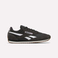 The Reebok Classic AZ Shoes in black feature white and gray accents, white side stripes, and a brown rubber sole that channels true '70s style, shown against a plain light background.