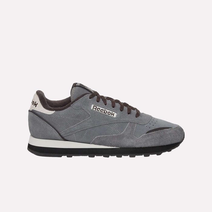 Classic Leather Premium LTD Shoes by Reebok in gray, featuring black laces, a timeless silhouette, black outsole, and white midsole, displayed in a side profile against a plain white background.