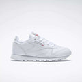 The Reebok Kids' Classic Leather Shoes - Preschool feature a white leather upper, white laces, low-top design, and subtle Reebok branding on the side and tongue, shown against a plain light background.