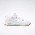 The Reebok Kids' Classic Leather Shoes - Preschool are shown in profile with a white leather upper, gum sole, white laces, stitching details, and the Reebok logo with a Union Jack flag on the side against a plain light background.