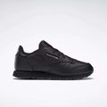 The Reebok Kids' Classic Leather Shoes - Preschool feature a black leather upper, low-top silhouette, lace-up closure, and subtle side branding, shown against a plain white background.