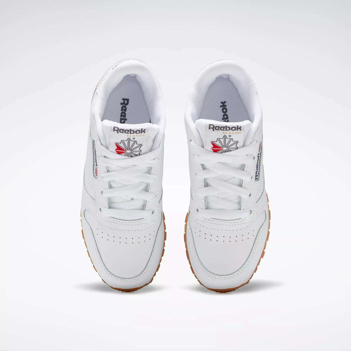 The Reebok Kids' Classic Leather Shoes - Preschool feature a white leather upper and lightweight cushioning, offering all-day comfort for kids.
