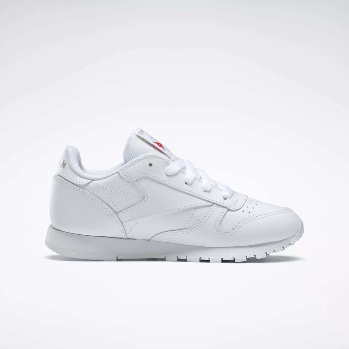 The Reebok Kids' Classic Leather Shoes – Preschool, featuring a white leather upper, white laces, and a rubber sole, is displayed in a side view on a light gray background.