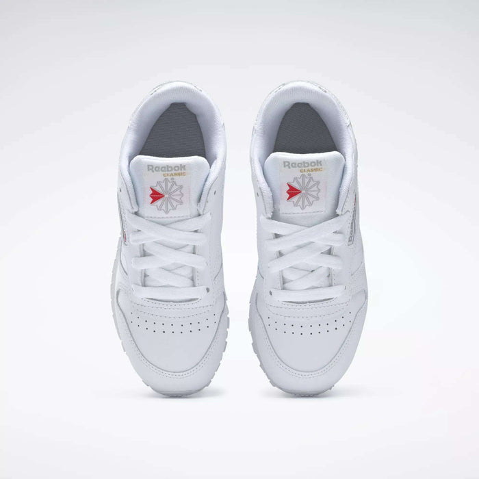 Top view of Reebok Kids' Classic Leather Shoes - Preschool, featuring a white leather upper, white laces, perforated toe boxes, and Reebok logos on the tongues against a plain white background.