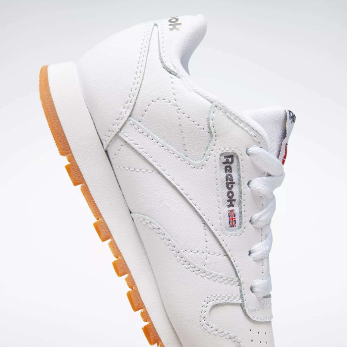 The Reebok Kids' Classic Leather Shoes - Preschool feature a white leather upper, gum sole, visible side logo, and white laces, shown on a white background.