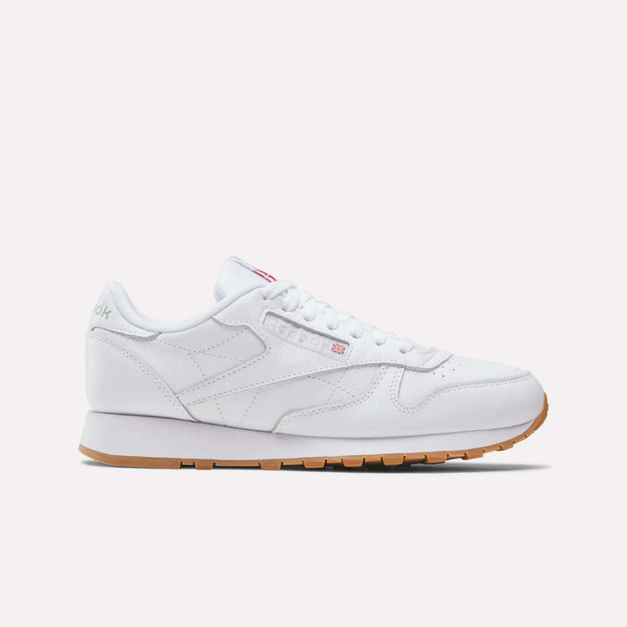 The Reebok Classic Leather Shoes feature a low profile, white leather upper, white laces, and retro gum rubber sole, shown in a side view against a plain light background.