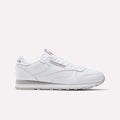 The Reebok Classic Leather Shoes feature a white leather upper, grey outsole, and subtle branding on the side and tongue, displayed in profile on a plain white background—a timeless retro style from Reebok.