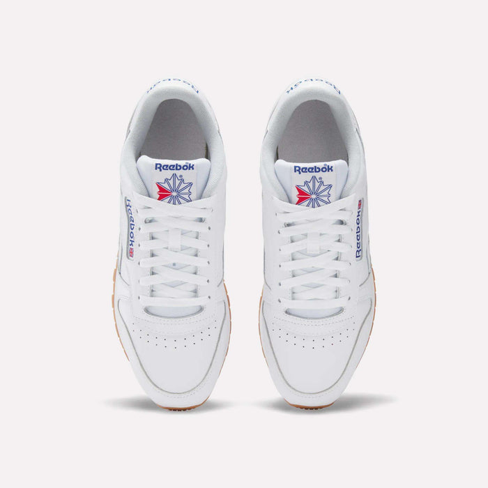 A pair of Reebok Classic Leather Shoes in white, seen from above, with white laces, a gum sole, and the iconic blue and red logo—these retro Reebok sneakers deliver timeless style.