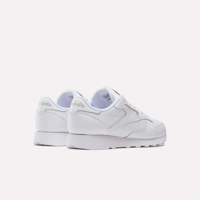 A pair of Reebok Classic Leather Shoes with a retro look, featuring white leather uppers and green heel branding, shown from an angled rear view on a plain white background.