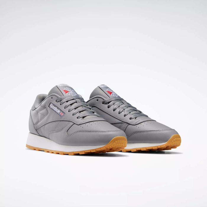 A pair of Reebok Classic Leather Shoes with gray leather uppers, light brown rubber soles, white midsoles, and Reebok logos on the sides, displayed against a plain white background.