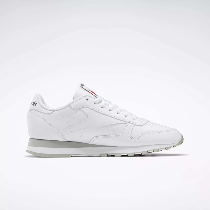 The Reebok Classic Leather Shoes feature a white, low-top leather design with white laces and a light gray sole, showcasing retro style. Displayed in profile against a plain white background.