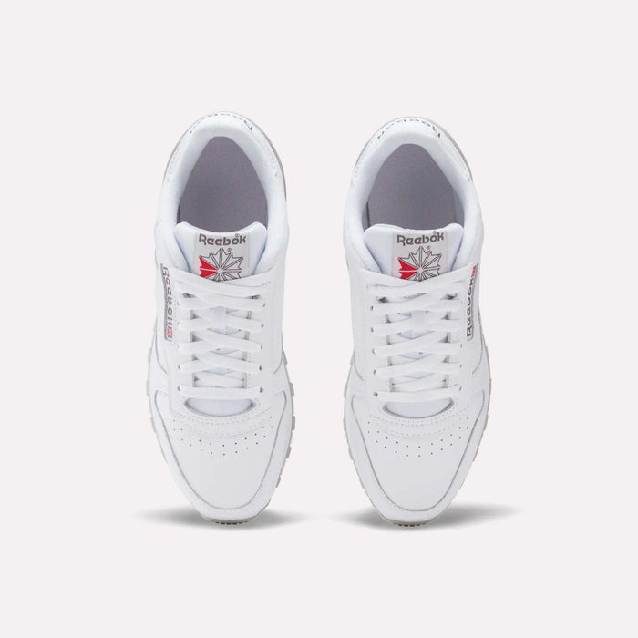 A top-down view of Reebok Classic Leather Shoes, featuring white uppers, laces, and the Reebok logo with red detailing on each tongue.