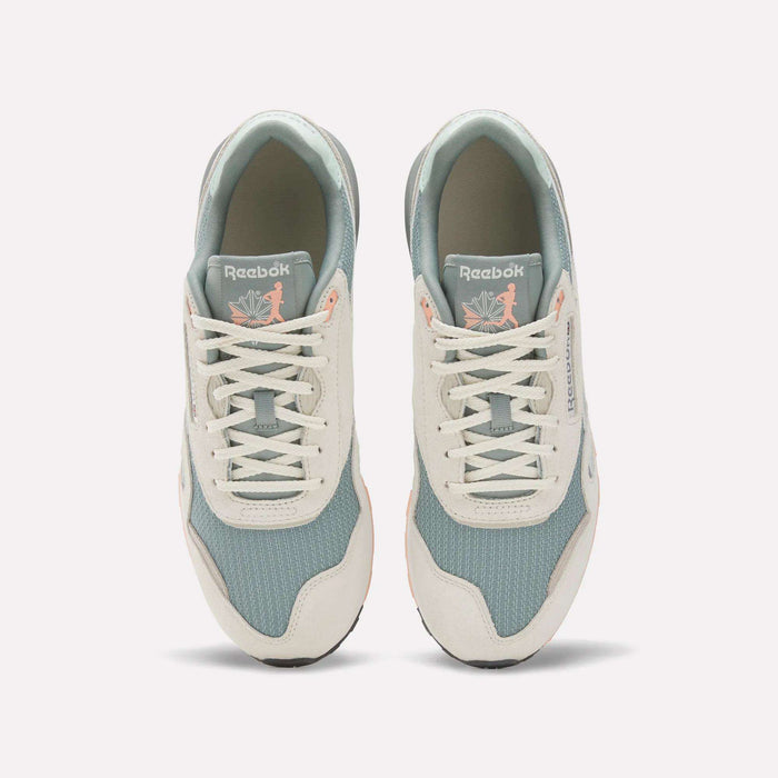 A top view of the Reebok Classic Nylon 89 Shoes shows light blue mesh, off-white suede overlays, and white laces. The cushioned midsole adds comfort, while insoles feature a pink flamingo with leaves for a unique touch.