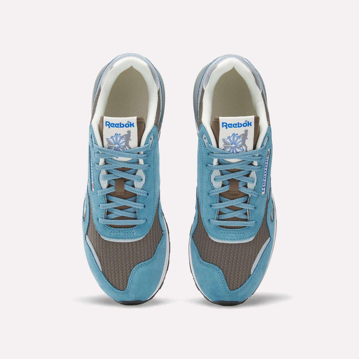 Top view of Reebok Classic Nylon 89 Shoes featuring blue suede overlays, brown mesh panels, grey accents, and a cushioned midsole. White tongue labels display the Reebok logo and vector. Stylish vintage running sneakers.