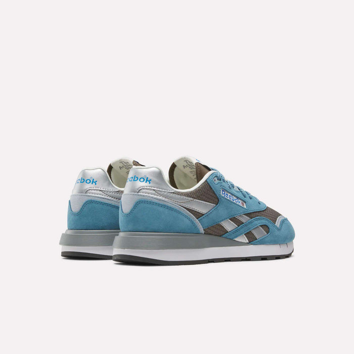 Reebok Classic Nylon 89 Shoes in blue, grey, and white are shown from the back and side on a white background. These vintage-inspired sneakers display the Reebok logo on both the heel and side.