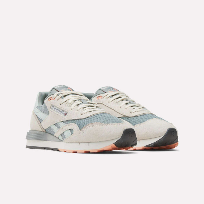 Reebok Classic Nylon 89 Shoes in pastel beige and light blue with white accents, grey soles, and peach details feature a cushioned midsole. Displayed side by side against a plain white background.