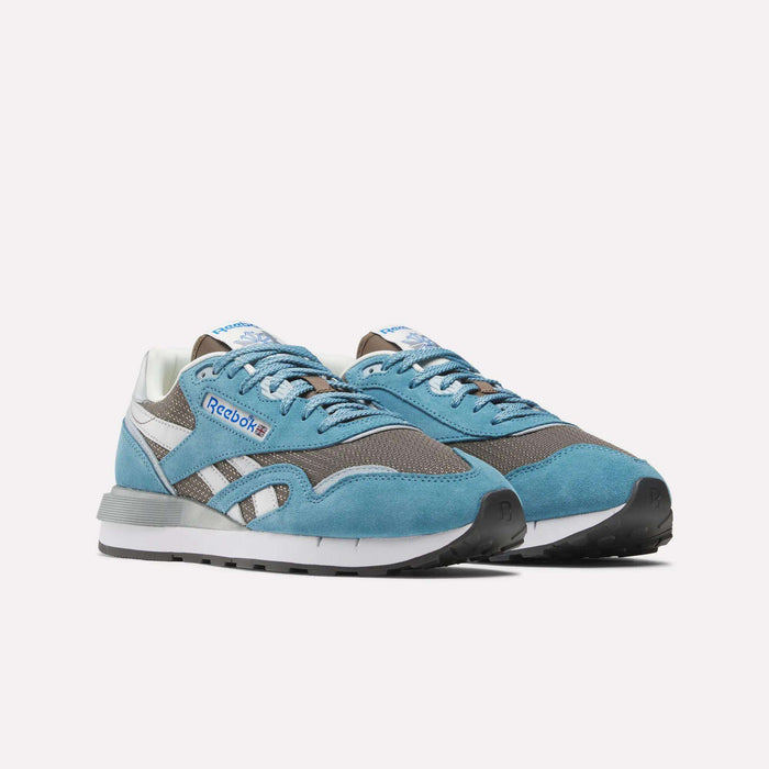 Reebok Classic Nylon 89 Shoes featuring blue suede, gray mesh panels, white accents, a cushioned midsole, and black rubber soles are displayed on a white background.