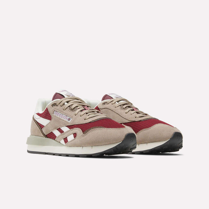 The Reebok Classic Nylon 89 Shoes in beige, white, and burgundy feature a suede and mesh upper, cushioned midsole, white side stripes, and black rubber soles, showcased against a plain white background.