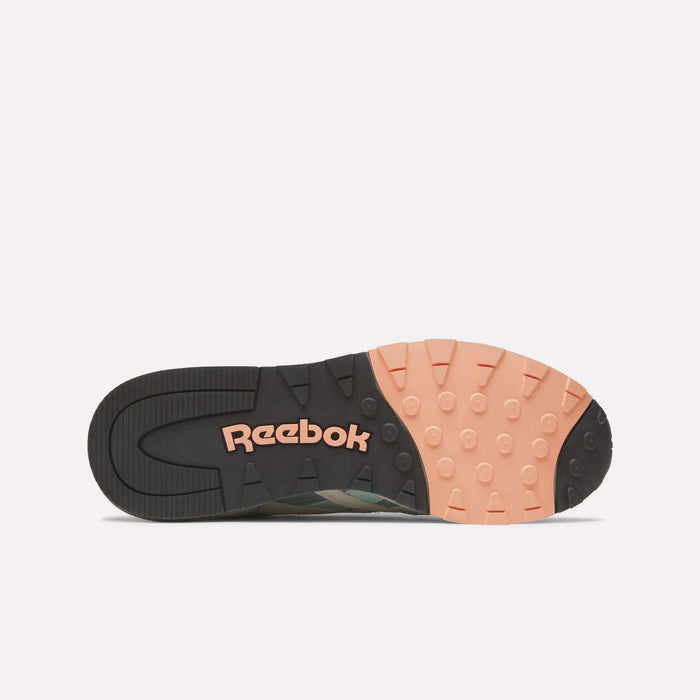 Bottom view of the Reebok Classic Nylon 89 Shoes, featuring a mostly black sole with a peach section, textured circular grips, a cushioned midsole for comfort, and vintage-inspired running shoe design for classic style.