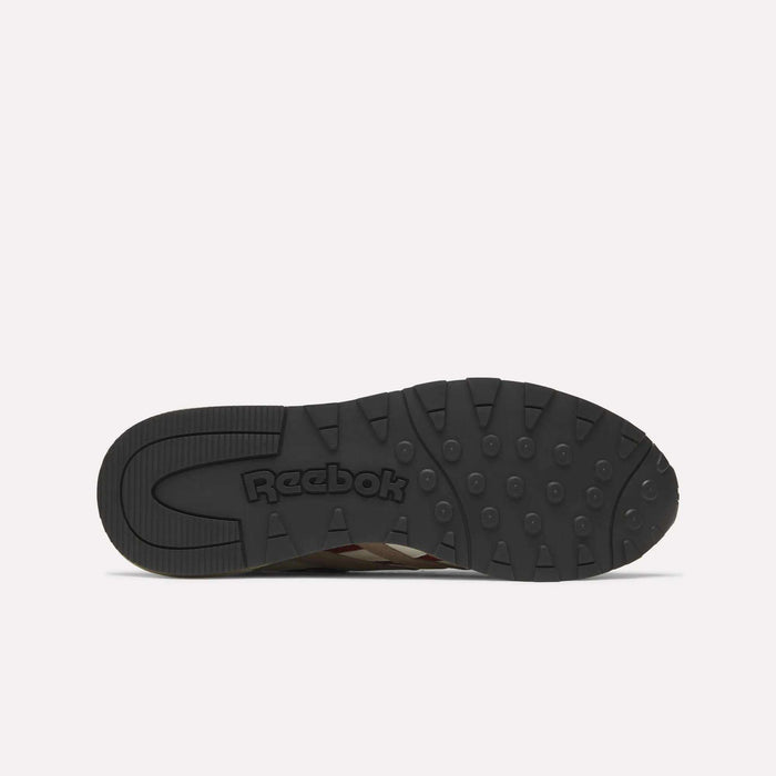 The image displays the black rubber outsole of a Reebok Classic Nylon 89 Shoe, viewed from below. It features circular grips, embossed Reebok branding near the heel, and suggests a cushioned midsole typical of classic running shoes.