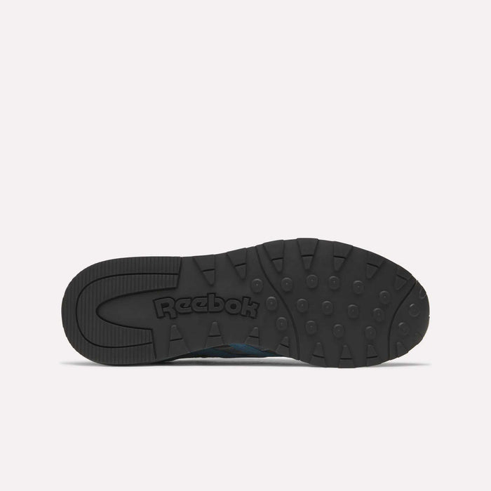The image displays the black rubber outsole of Reebok Classic Nylon 89 Shoes from below, featuring circular tread patterns, a cushioned midsole, and an embossed Reebok logo at the center against a plain white background.