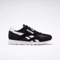 The Reebok Classic Nylon Shoes - Big Kids are displayed in black and white from a side angle on a white background, showcasing the iconic Reebok logo, white stripes, and sole—ideal for those who love minimalist style.