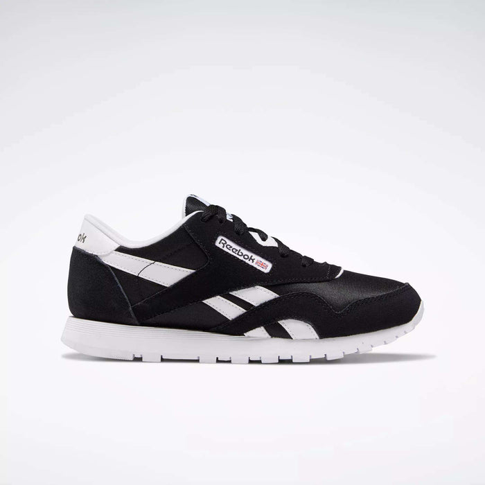 The Reebok Classic Nylon Shoes - Big Kids are displayed in black and white from a side angle on a white background, showcasing the iconic Reebok logo, white stripes, and sole—ideal for those who love minimalist style.