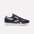A pair of Reebok Classic Nylon Shoes for Big Kids in Dark Indigo, New Grey 1, and Midnight Tide is shown in profile against a plain light background. Featuring a white sole, dark indigo suede overlays, and crisp side stripes, these sneakers combine comfort with timeless style—making them an excellent choice for boys’ footwear.
