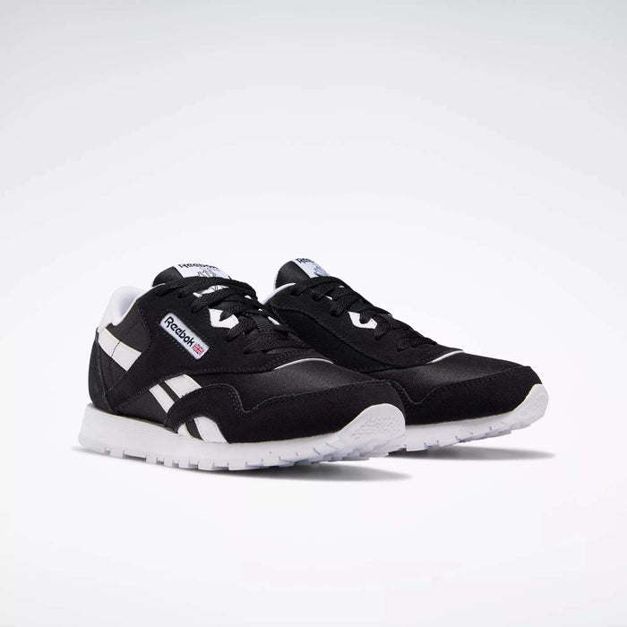 Reebok Classic Nylon Shoes - Big Kids in black with white accents and soles, showcasing a minimalist design inspired by iconic 80s running shoes.