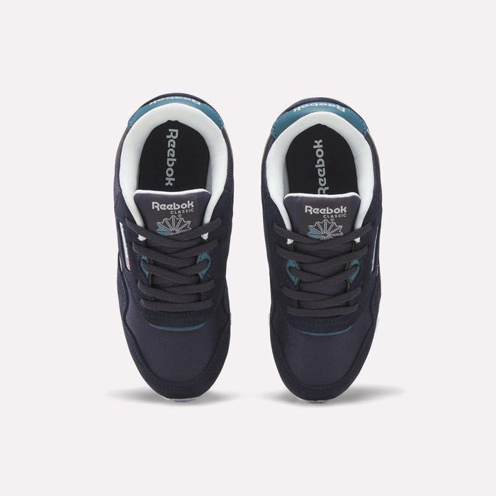 A pair of Reebok Classic Nylon Shoes - Little Kids in navy blue, featuring black laces and white Reebok logos on the tongues and insoles, viewed from above on a plain light background—ideal for boys’ shoe collections.