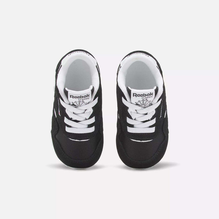 A pair of Reebok Kids' Classic Nylon Shoes for toddlers is shown from above on a white background. The shoes feature a black and white suede and nylon upper, white laces, and the Reebok logo on the tongue.