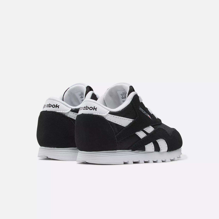 A pair of Reebok Kids' Classic Nylon Shoes - Toddler in black and white are displayed on a white background, angled to highlight the back, side details, signature stripes, and Reebok branding.