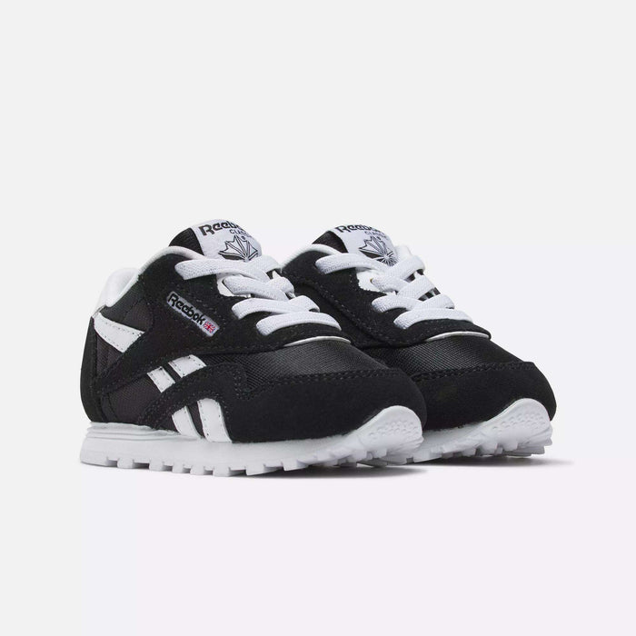 Reebok Kids' Classic Nylon Shoes for toddlers in black and white, featuring a suede and nylon upper, white laces and soles, plus Reebok logos on the side and tongue, are shown against a plain white background.