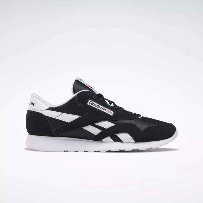 The Reebok Men's Classic Nylon Shoes in black and white feature white side stripes, a white sole, and signature Reebok logos—ideal everyday sneakers for men—displayed in a side profile on a plain light background.
