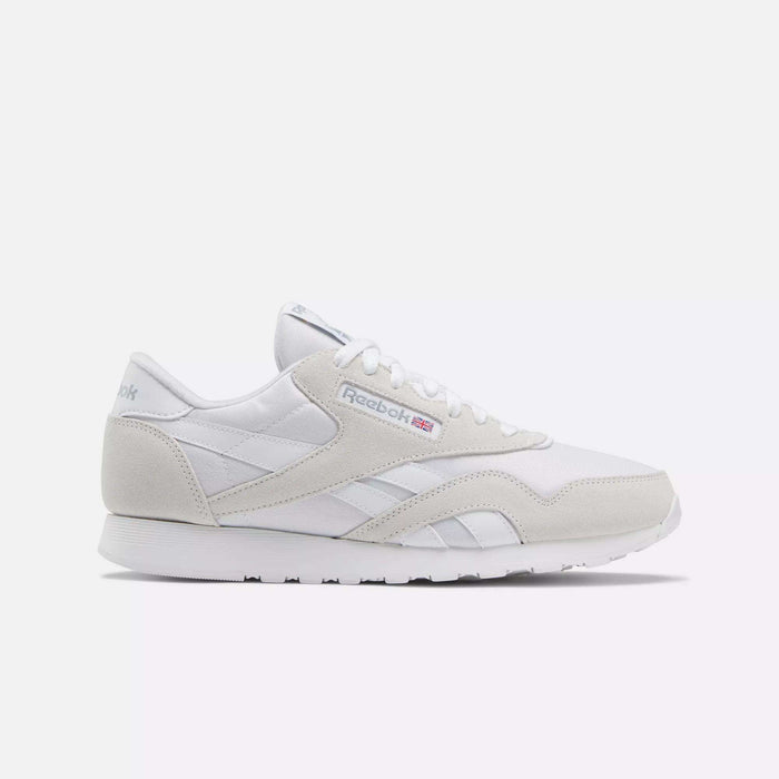 The Men's Classic Nylon Shoes by Reebok feature a white and light gray design with suede and leather details, plus the Reebok logo and British flag. Perfect for everyday wear, these sneakers are displayed on a plain white background.