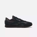 The Men's Classic Nylon Shoes by Reebok feature a low-profile, lace-up design in black with a nylon upper and the Reebok logo plus Union Jack flag on the side, shown against a plain white background.