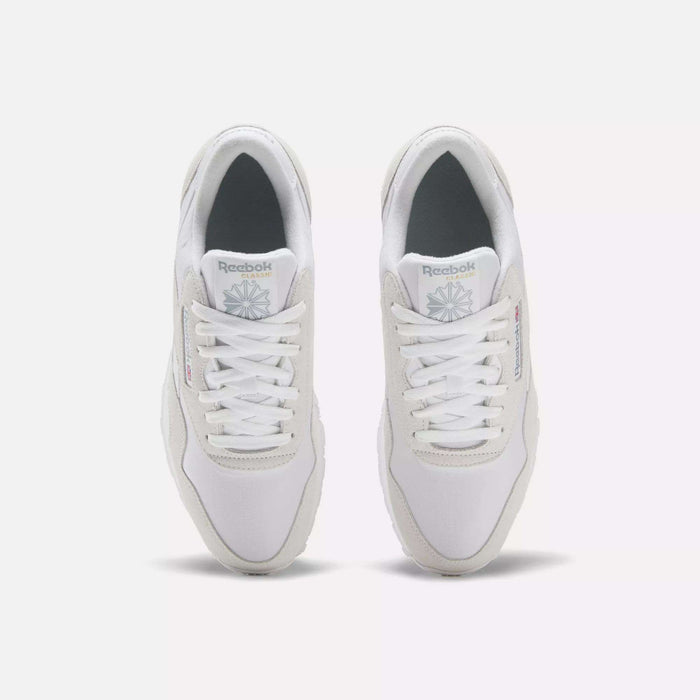 A pair of Men's Classic Nylon Shoes by Reebok in white, seen from above with white laces, light gray accents, and the Reebok logo on the tongue and side—timeless sneakers set side by side on a plain white background.