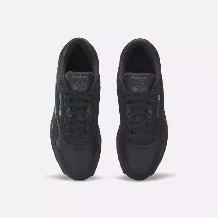 A pair of Men's Classic Nylon Shoes by Reebok, shown from above on a white background, features a black nylon upper, laces, tongue logo, and subtle side branding.