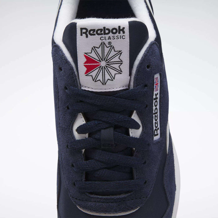 Close-up of the Men's Classic Nylon Shoes by Reebok, showcasing a navy upper, matching laces, and an iconic tongue with the Reebok logo and UK flag tag—timeless everyday sneakers for men.