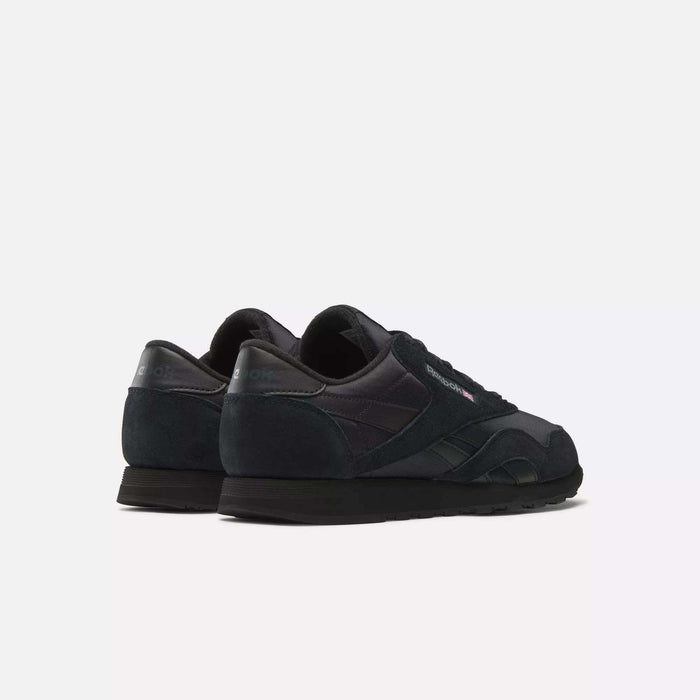A pair of black Reebok Men's Classic Nylon Shoes is displayed on a white background with heels forward and angled right. These everyday sneakers have a durable nylon upper for comfort and style.